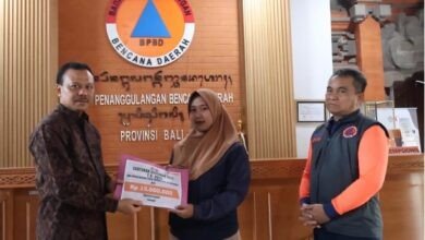 Sekretaris Daerah (Sekda) Provinsi Bali, Dewa Made Indra, menyerahkan santunan kepada ahli waris korban banjir yang melanda beberapa wilayah di Bali pada Jumat (19/9/2025) di Kantor BPBD Provinsi Bali, Renon, Denpasar. (dok.istimewa)